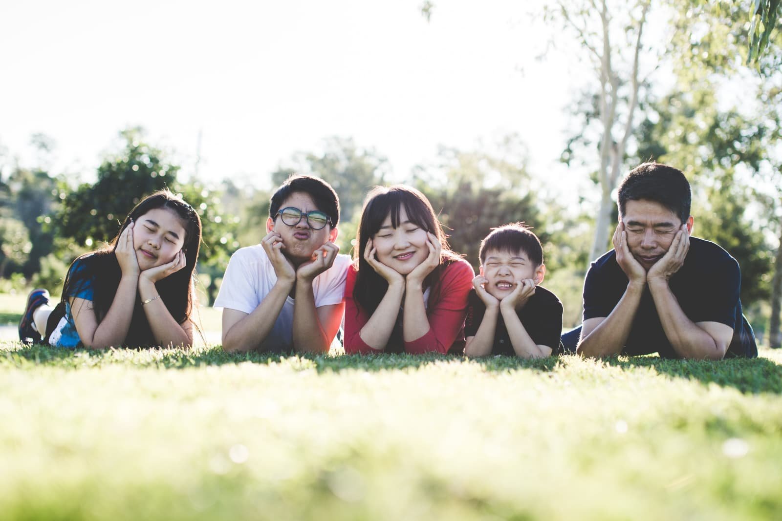 Family lying together in the grass